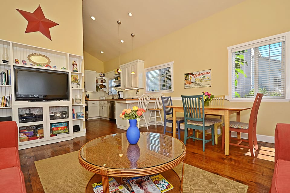 Great room with dining table and entertainment center.