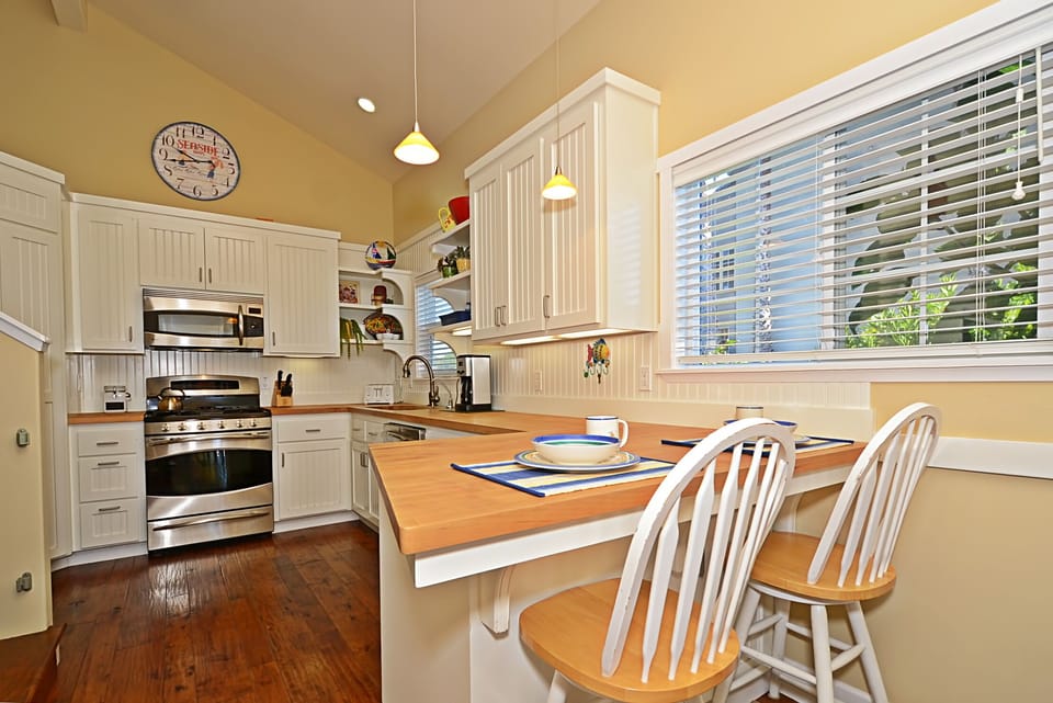 A cheery kitchen with breakfast bar and newer appliances.