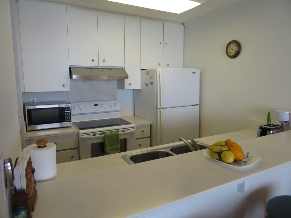 Looking into Kitchen from living room & bar seating area.