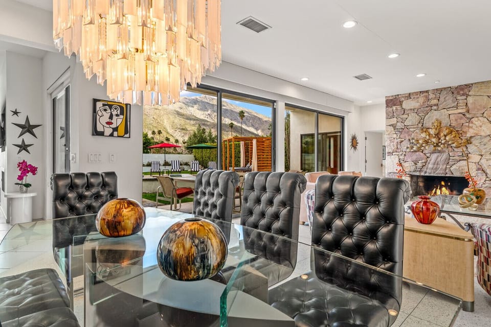 Dining with views toward the pool and outdoor living spaces