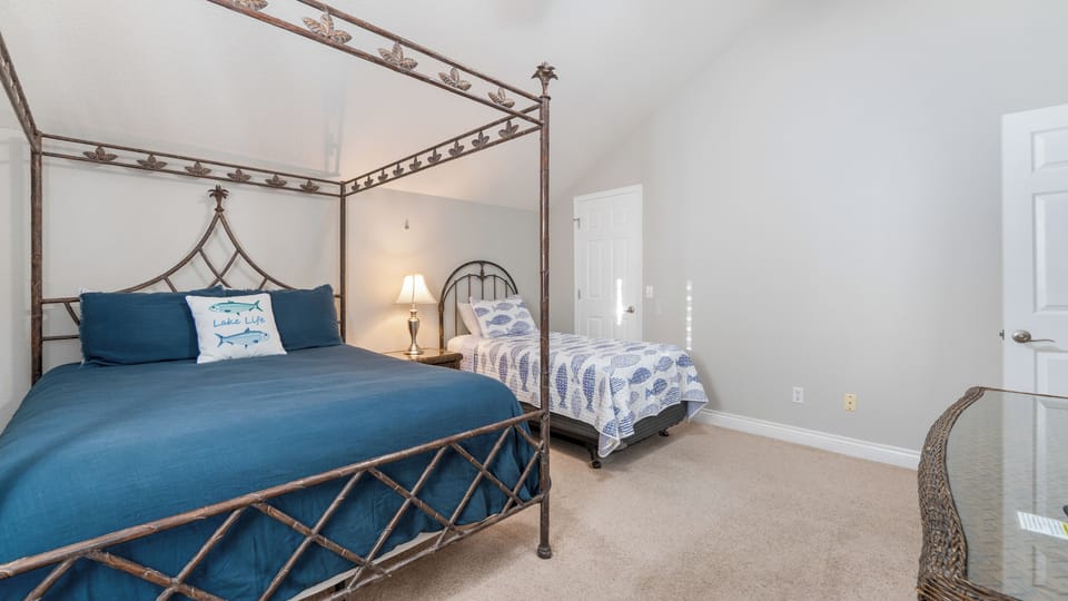 upstairs 4th bedroom with queen bed and a twin bed