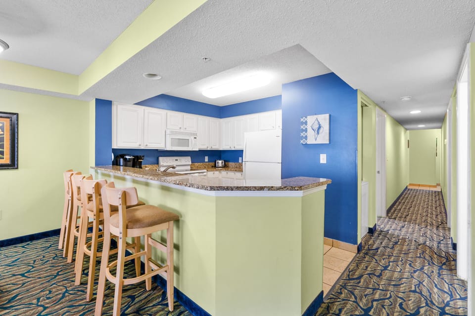 Large kitchen with bar stools for additional seating 