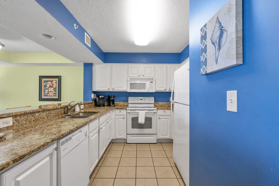 Large kitchen with granite counter tops, flat top stove and dishwasher