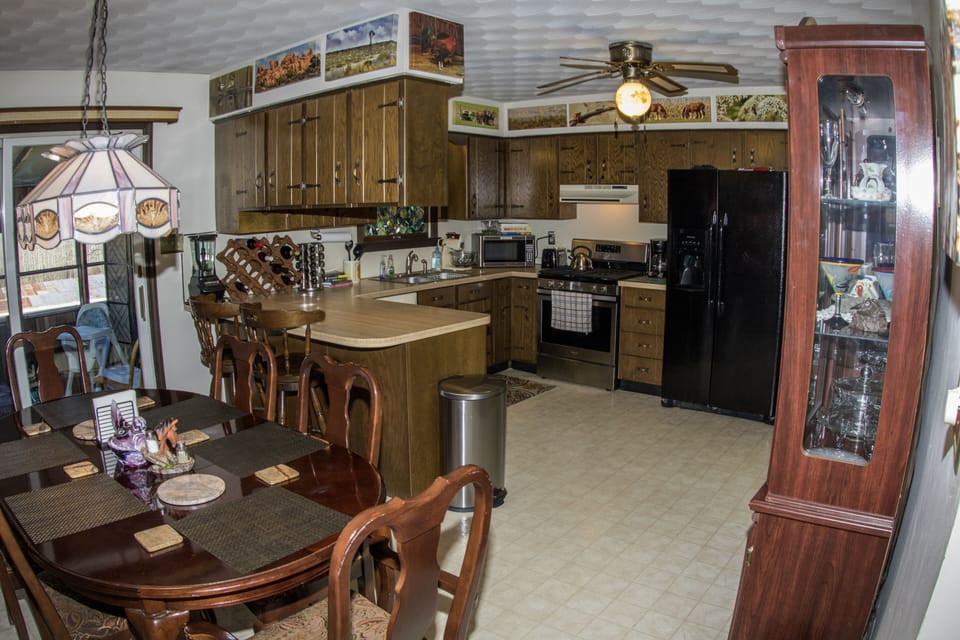 Fully equipped kitchen featuring convection oven and side by side refrigerator