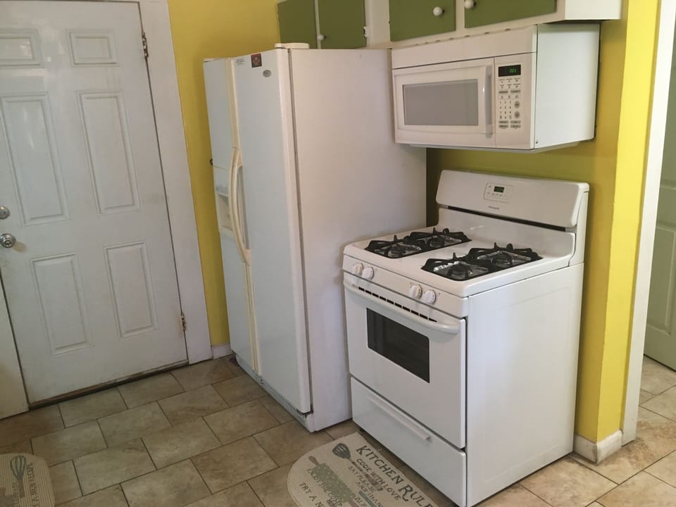 Gas stove,  Microwave and Refrigerator with ice make and water dispenser.