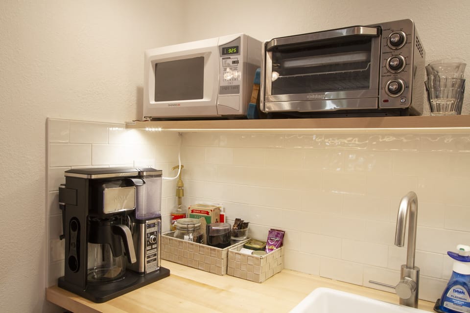 Coffee Maker, Toaster Oven, Microwave, snacks, coffee and teas provided.
