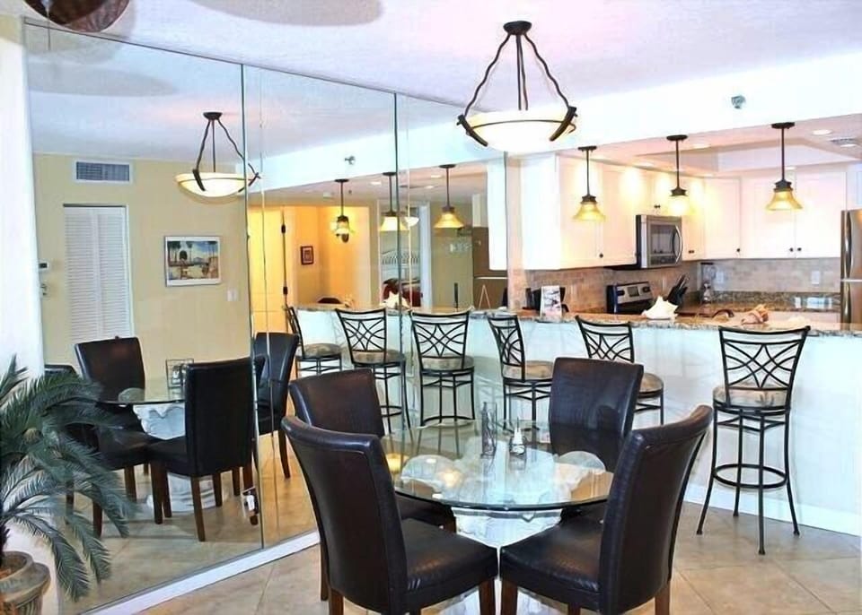 Dining table with 4 leather chairs, plus 3 more chairs at the breakfast bar!