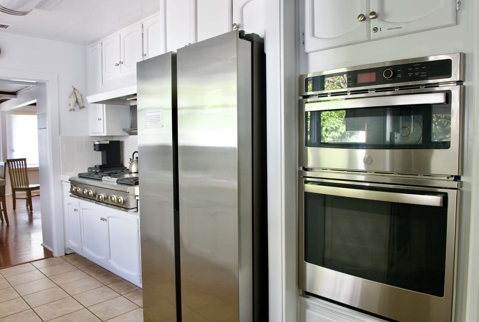 Updated appliances and commercial gas burner stove with griddle.