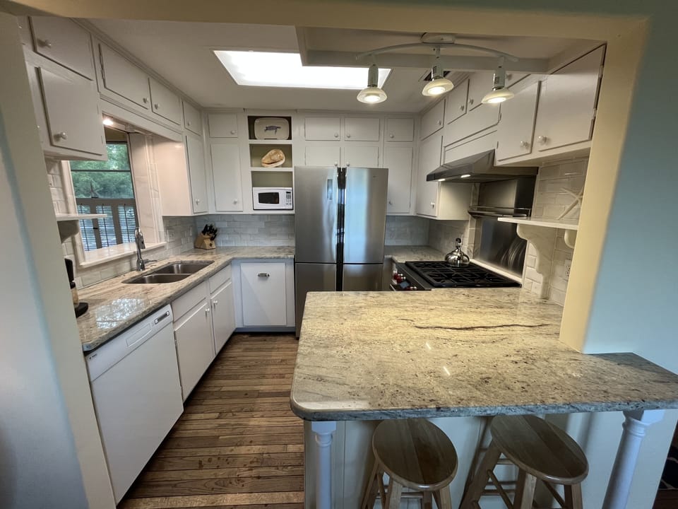 Full kitchen with granite countertops and marble backsplash.  Wolf Oven.  