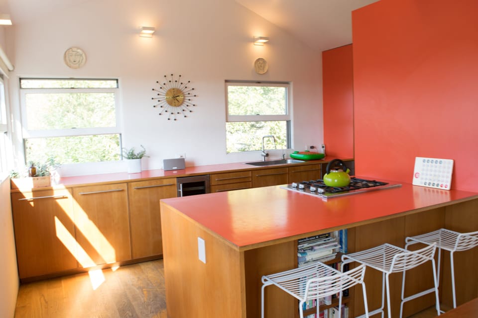 Bright kitchen with sub-zero fridge, stove top, oven, microwave, wine cooler