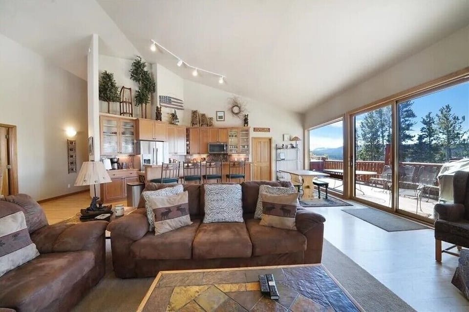 Vaulted ceilings in the great room with kitchen, dining areas, and living room