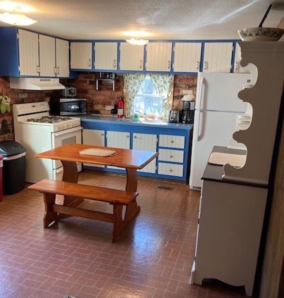 Country kitchen with small work table and bench