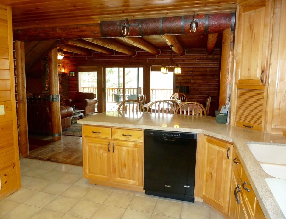 Kitchen opens to dining and living area with eating bar that seats 3.