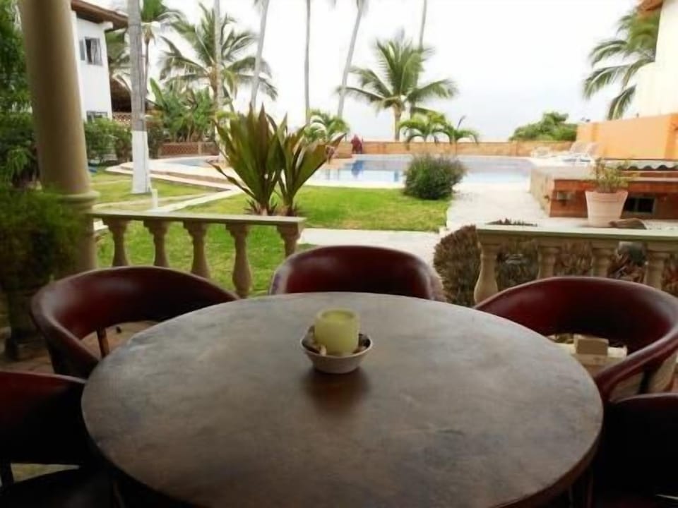 Large Outdoor Patio dining for 6.  Beach is just beyond short pool wall.