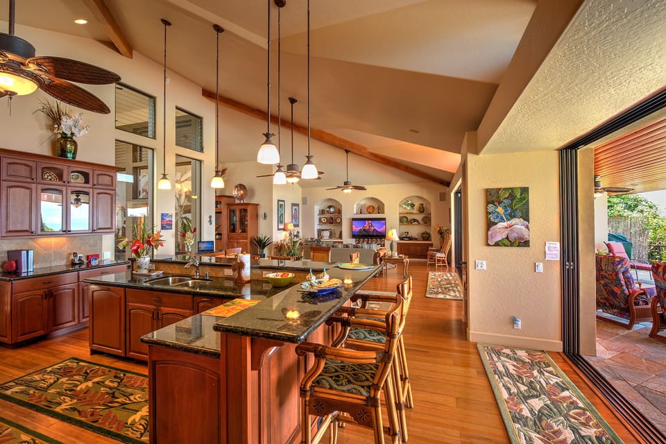 The kitchen looks into the living room and out to the lanai.