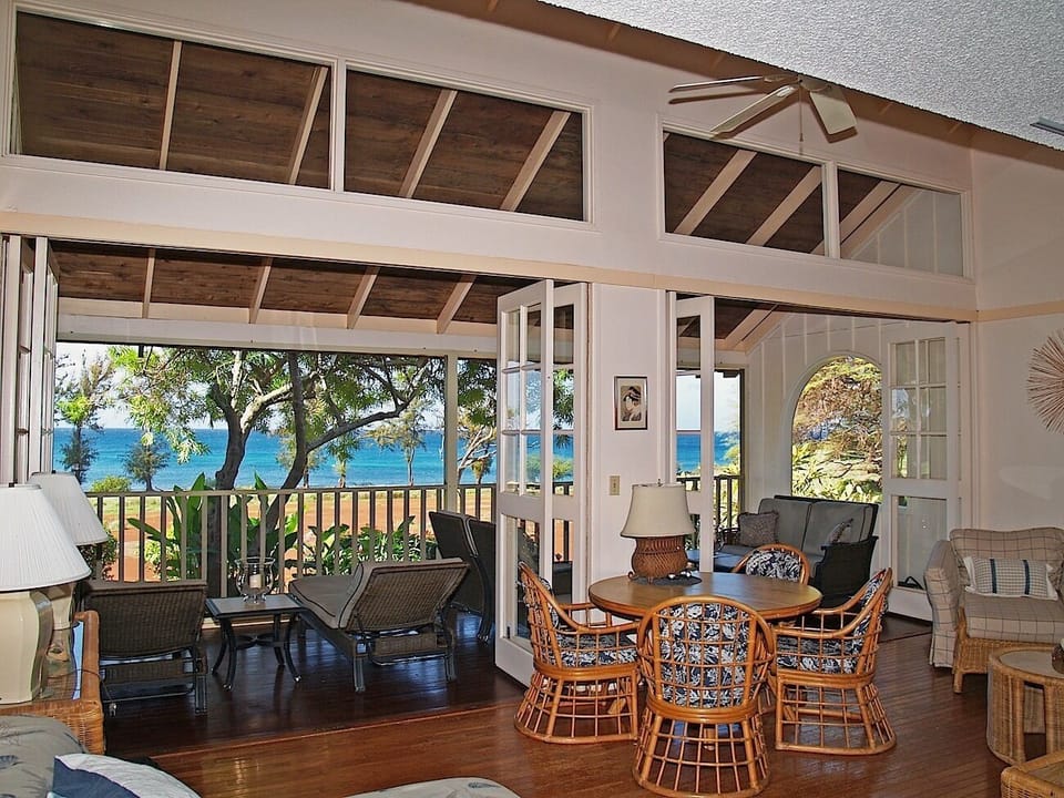 Living room with screened lanai with spectacular ocean and sunset views