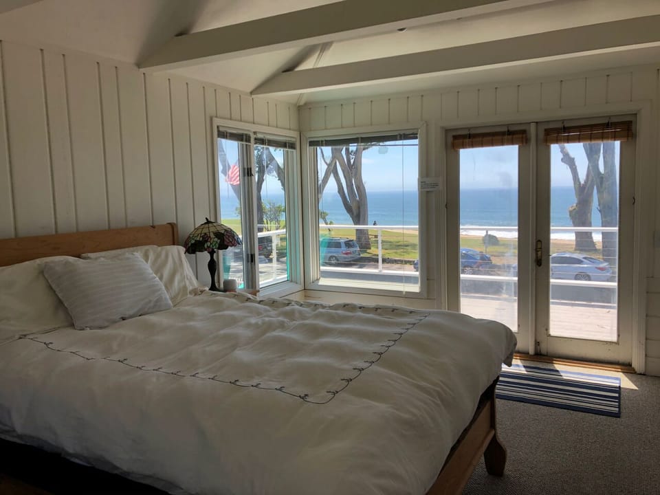 Upstairs Bedroom with queen bed, lofted ceilings and stunning ocean views