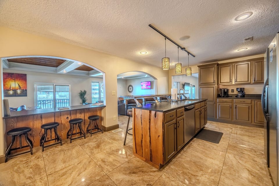 "Spacious kitchen with a central island, bar seating, and cozy living area."