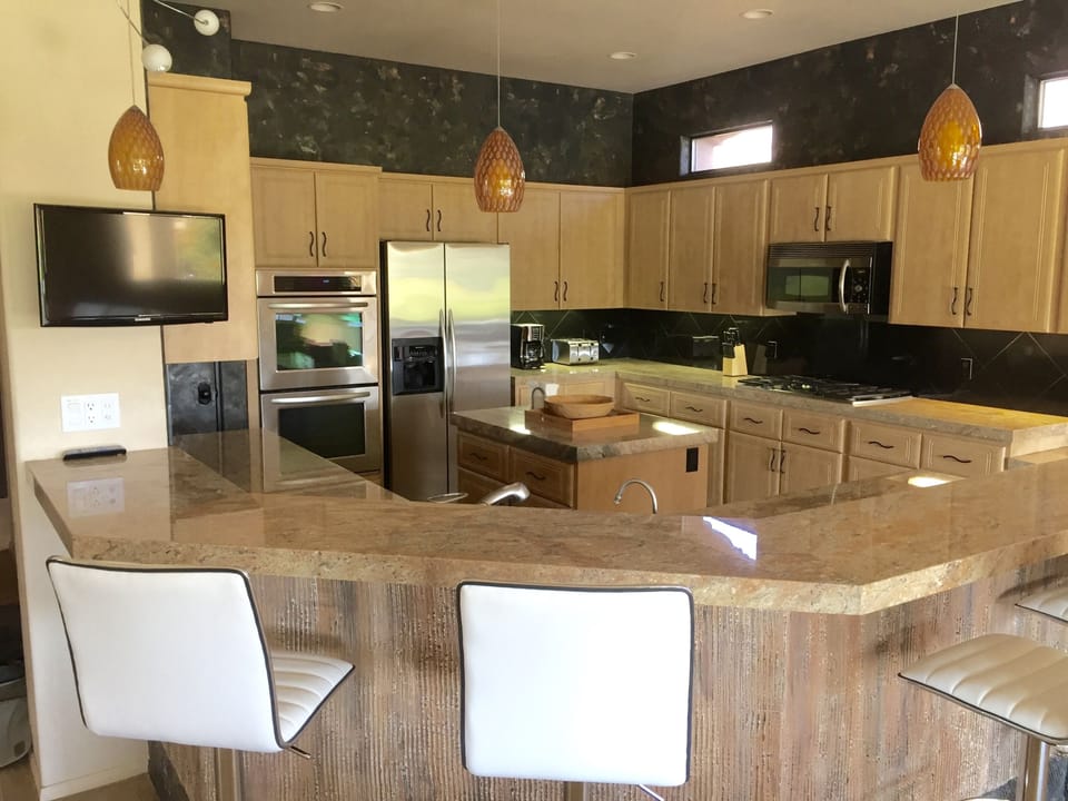 Spacious island kitchen, with double oven, and LED tv positionable any direction