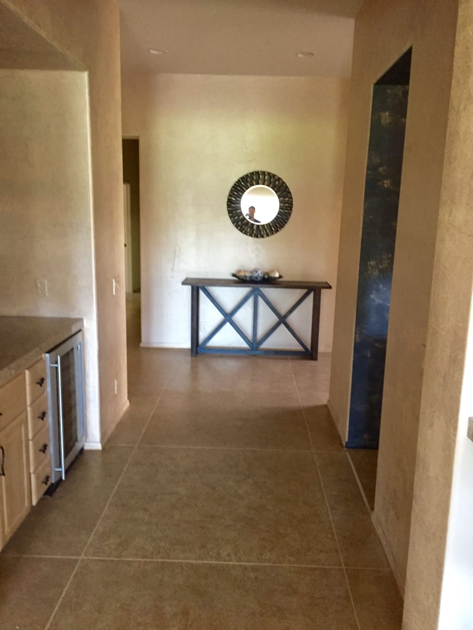 Main hallway features a wet bar with wine fridge (see left) to greet guests