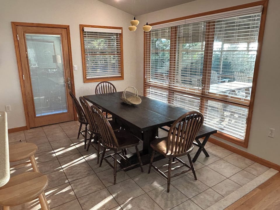 Dining room on upper floor with solid, barn door table. Seats 9 (June 7, 2024)