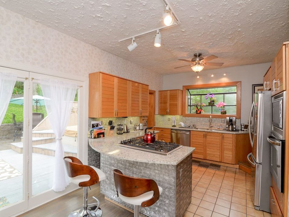 Kitchen and rear patio entry door and food service bar.