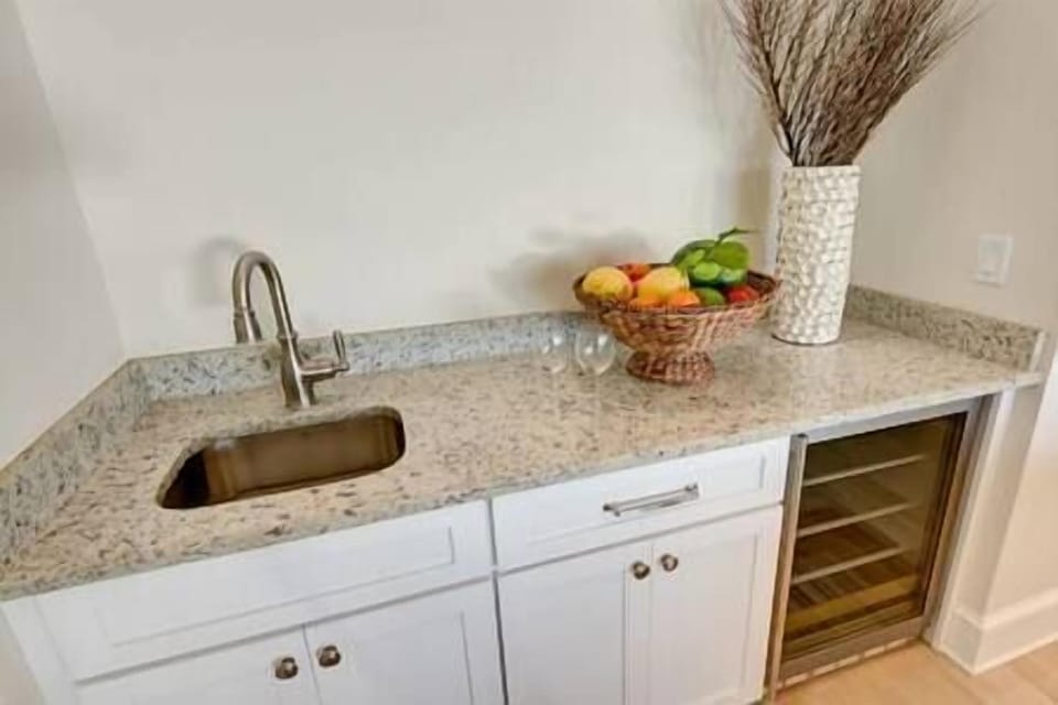 Wet bar adjacent to the living room with a convenient beverage fridge.