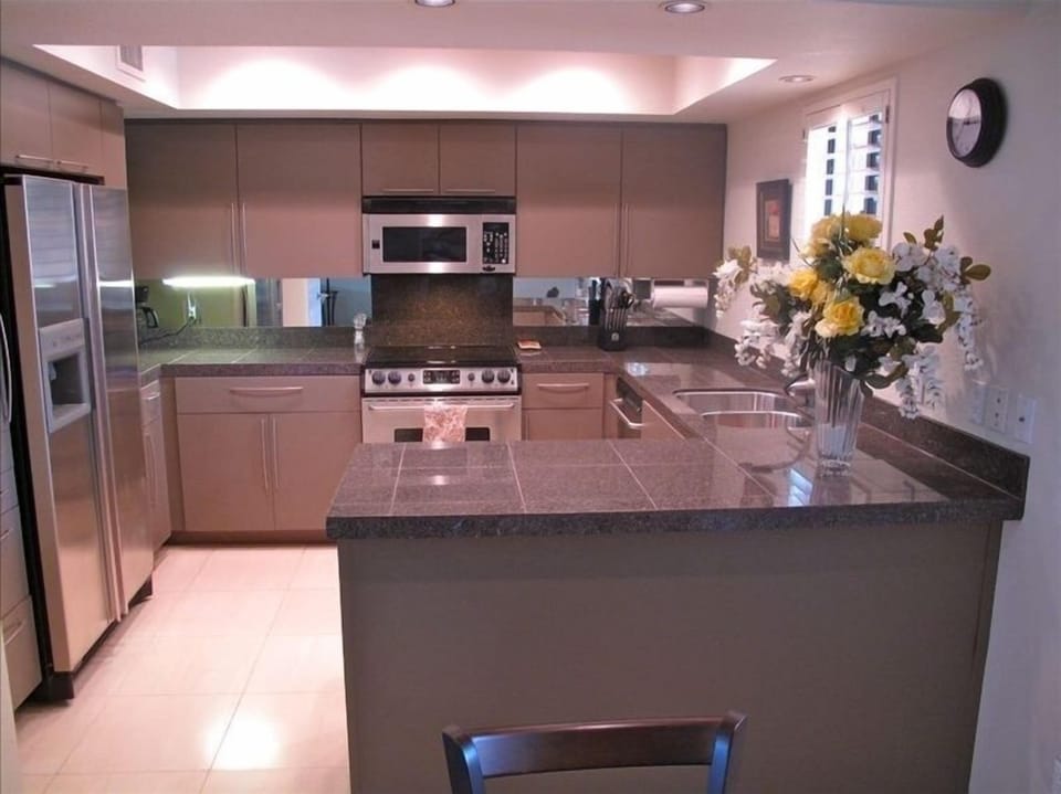 Fully stocked gourmet kitchen with granite countertops and custom cabinetry