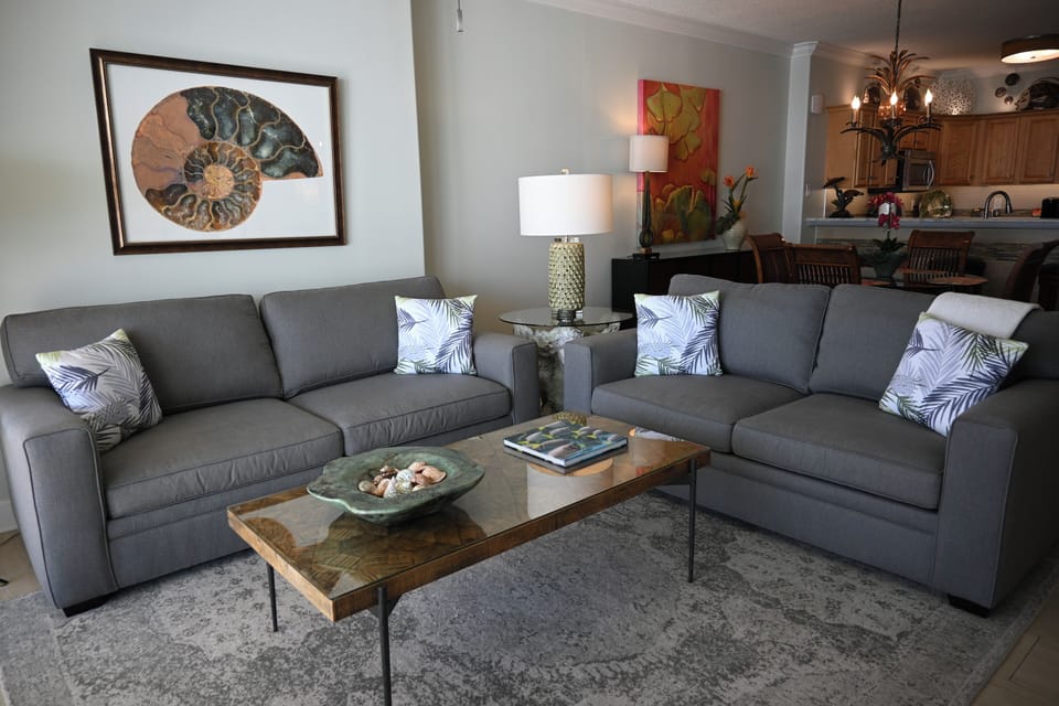 Living room sofa can convert to a queen sleeper with an upgraded mattress.