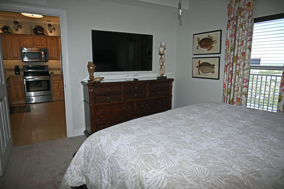 Dresser and large flat screen TV in guest bedroom.