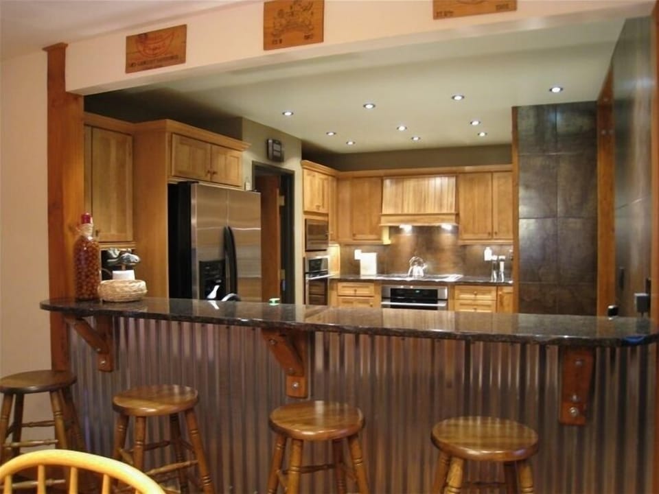 Our all new kitchen with stainless steel appliances and bar seating for 4