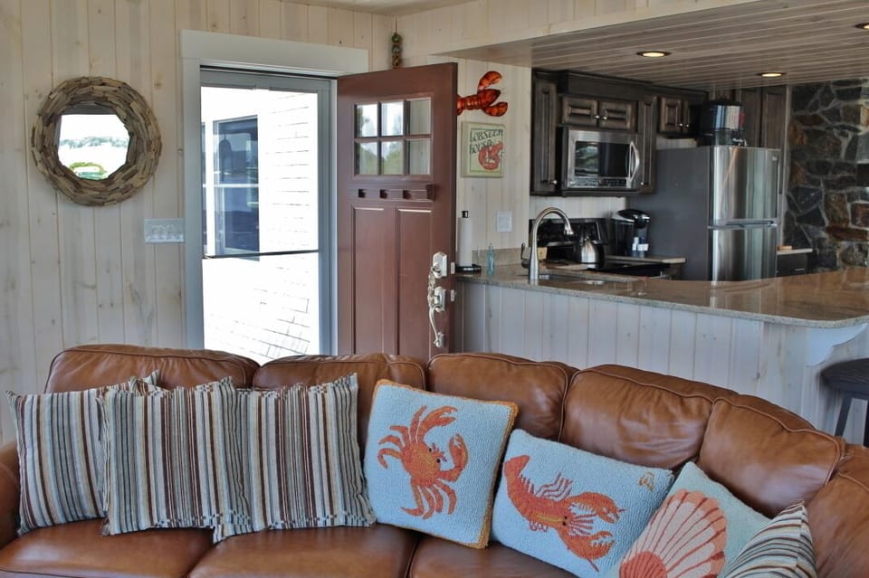 Couch facing east with views of beach, Garrison Cove, Cribstone Bridge & Orrs Is