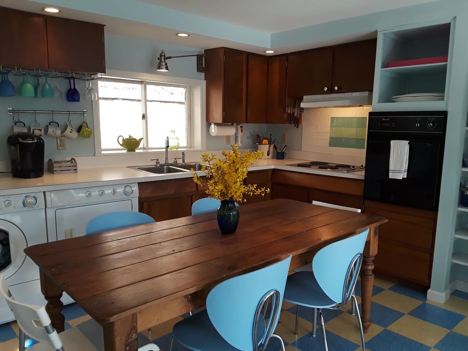 Fully outfitted kitchen with country wood table