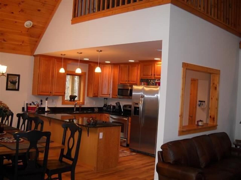view into kitchen, sitting loft above looking down on dining & living rooms