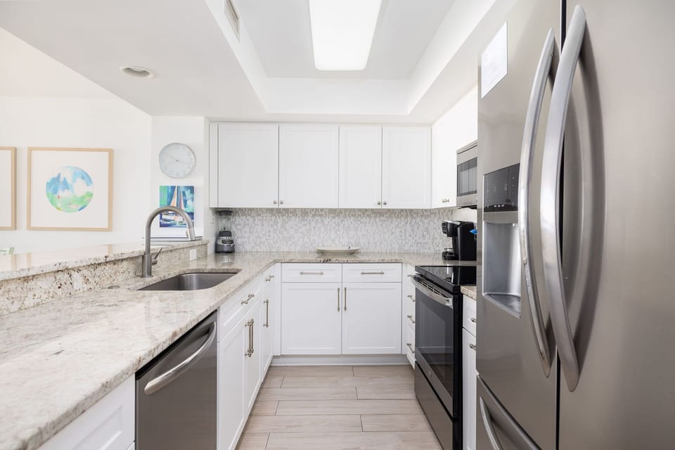 Fully equipped kitchen with sleek appliances, ample counter space, and everything needed for a beachfront stay.