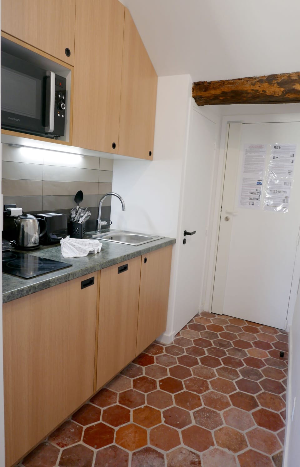 COSY 5 - Kitchen location is close to the dining area and the entrance.