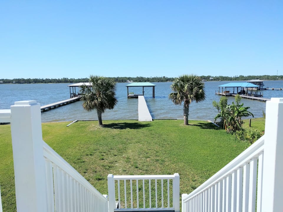 View from the sundeck of the spacious yard, private pier and boathouse