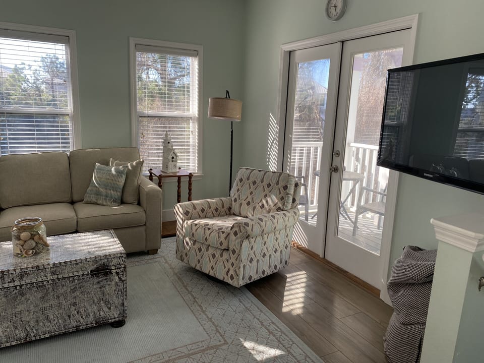Open living room with access to private deck.  