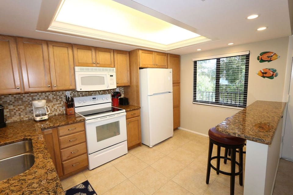 The kitchen has a convenient breakfast bar. 