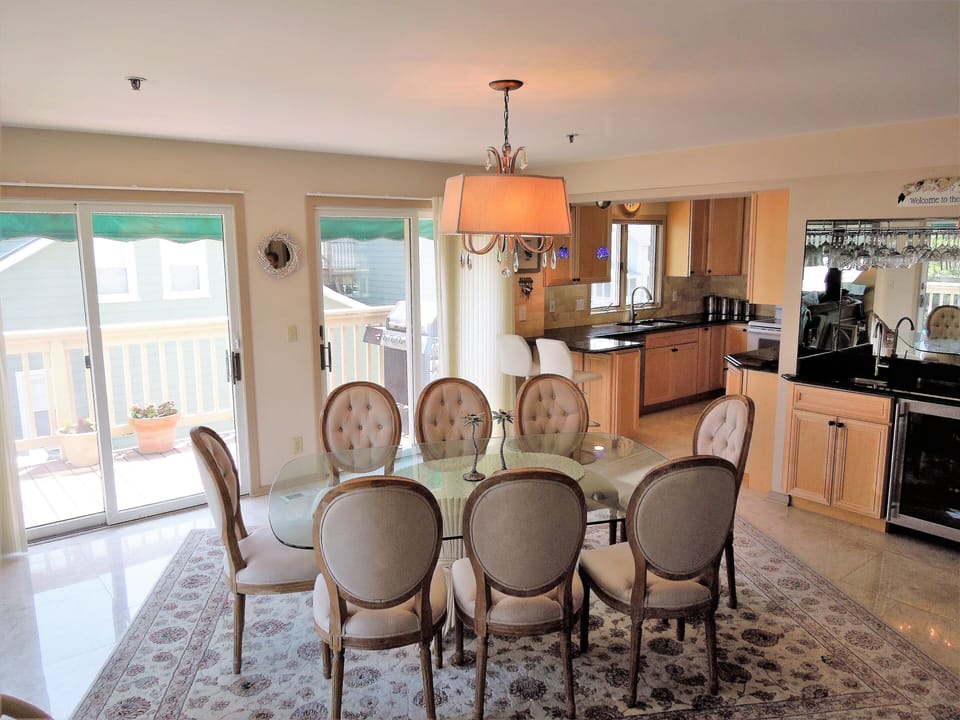Dining area, wet bar, and kitchen + sliding glass doors to the wrap around deck
