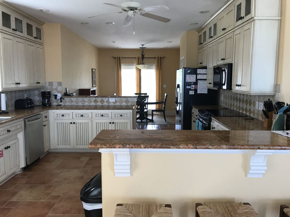 Kitchen looking into breakfast room with additional seating for 4