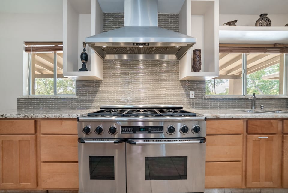 Chef-grade gas range, six burners, dual ovens. Bring the whole crew and still get dinner out hot.