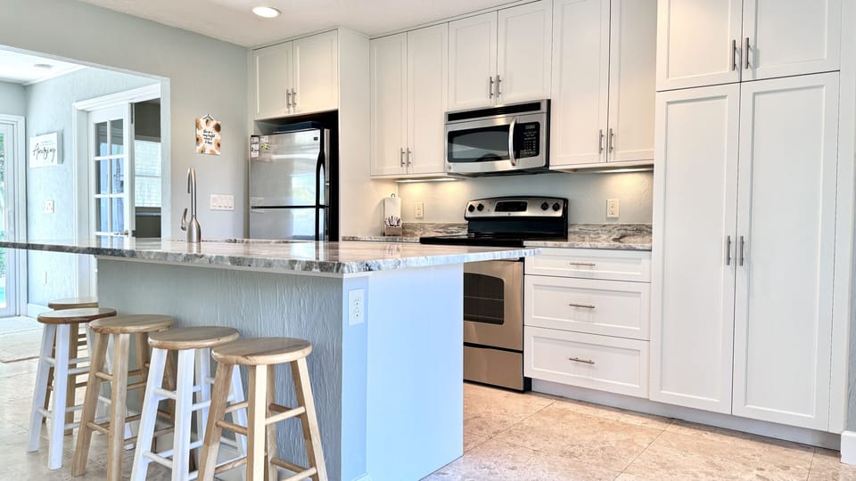 Fully furnished kitchen area with seating at the island.