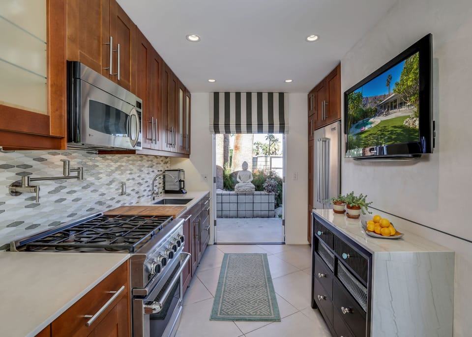 Chef's kitchen with professional gas range, ss appliances & close to outdoor BBQ
