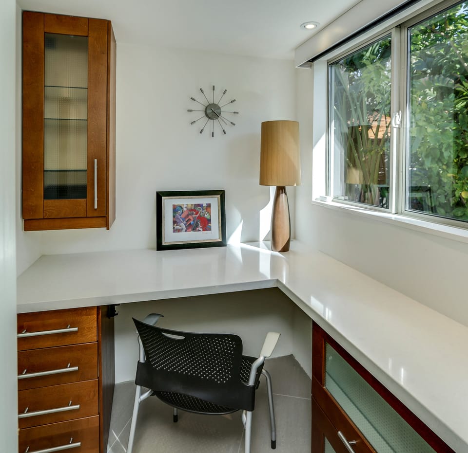 Handy office w/ privacy door, quartz counters & cabinet storage + backyard views