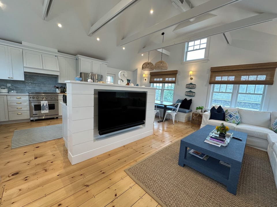 Upstairs living area across from kitchen and dining with large flat screen TV