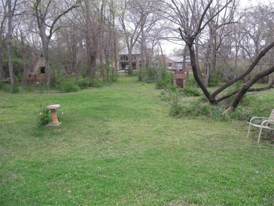 Large backyard with birdbaths, an old hideout and lots of trees.