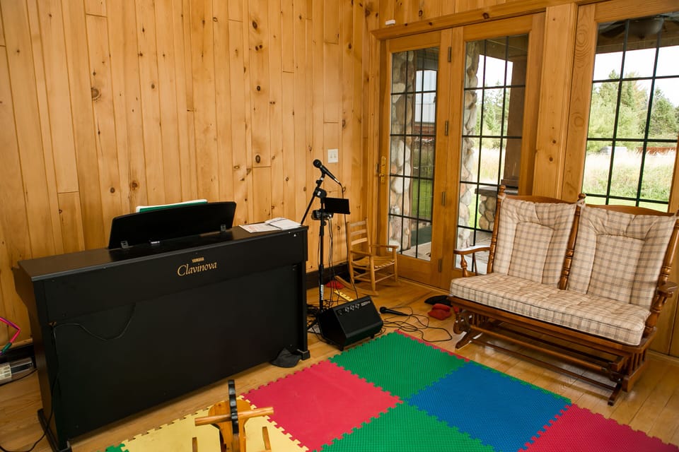 The music room with a piano and karaoke machine at the ready...
