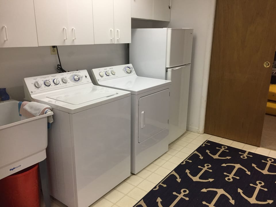 Full size washer and dryer in the basement and an extra fridge
