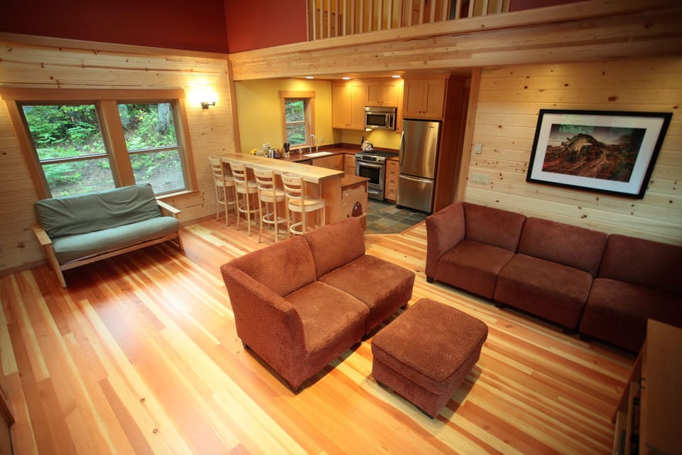 Living area and kitchen. The green futon couch can be setup as a 3rd queen bed.
